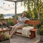 Brown wooden garden bench “Riva” with backrest for terrace use.